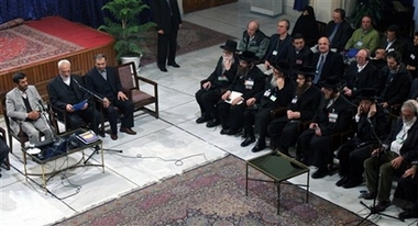 Iranian President Mahmoud Ahmadinejad, left, meets participants of a conference on the Holocaust, as anti-Zionism Rabbis sit at the first row at right, in Tehran, Iran, Tuesday, Dec. 12, 2006.