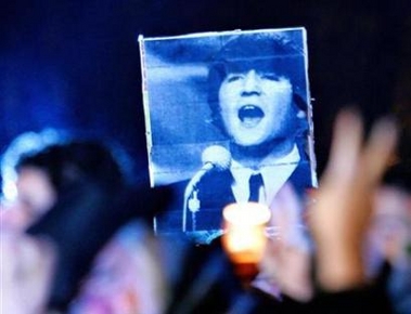 A fan holds up a picture of John Lennon at a candlelight vigil on the 25th anniversary of Lennon's death at Strawberry Fields in Central Park in New York City, December 8, 2005. The FBI has released the last 10 documents from its secret files on Lennon that had been withheld for 25 years on the ground they could prompt 'military retaliation' against the United States, campaigners for their release said on Wednesday. (Peter Foley/Reuters) 