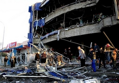 People check debris after a parked car bomb also exploded in the center of Kirkuk, 290 kilometers (180 miles) north of Baghdad, Iraq, Wednesday Jan. 10, 2007. There was no immediate report on casualties. (AP