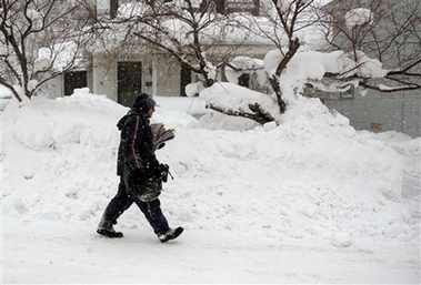 Letter carrier Don Feltt makes his appointed rounds delivering the mail in Oswego, N.Y., Saturday, Feb. 10, 2007. (AP