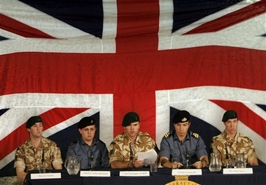 Backdropped by Britian's flag, five of the fifteen British military personnel freed by Iranian authorities Thursday, are seen during a news conference at the Royal Marines Barracks in Chivenor, England, Friday April 6, 2007.