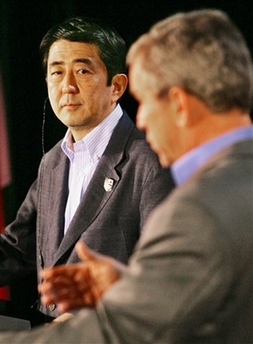 Japanese Prime Minister Shinzo Abe,left, listens as President Bush responds to a reporter's question during their joint news conference,, Friday, April 27, 2007, at Camp David, Md. (AP