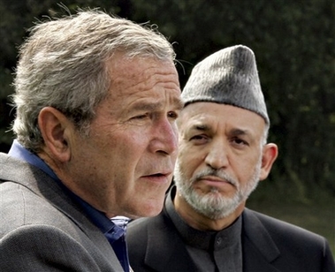 President Bush, left, accompanied by Afghanistan's President Hamid Karzai, right, speaks during their joint press conference, Monday, Aug. 6, 2007, at Camp David, Md. (AP