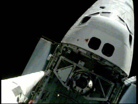 Shuttle docks with space station