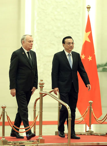 Chinese Premier Li Keqiang welcomes French Prime Minister Jean-Marc Ayrault inside the Great Hall of the People in Beijing December 6, 2013. Premier Li holds talks with French counterpart