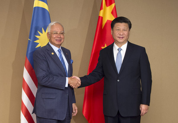 Xi pledges 'priority' to ties with Malaysia in China's neighborhood diplomacy