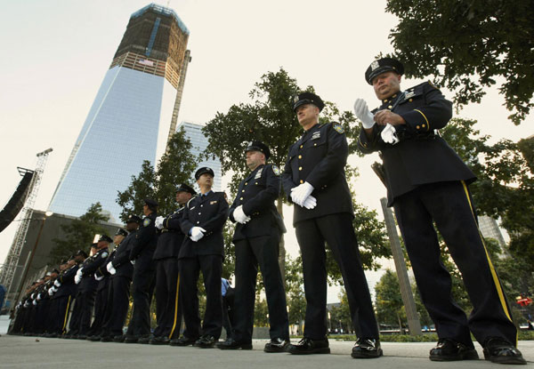 New York police, firefighters and Port Authority Police line up at one of the entrances of 9/11 Memorial Plaza before the tenth anniversary ceremonies at the World Trade Center site in New York, Sept 11, 2011. The 9/11 attacks changed life in the United States forever, but 10 years after the devastating hit, New Yorkers have learned to live in a more dangerous world and are ready to move on. Mourning for 9/11 victims