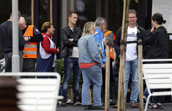 Rescue workers stand outside the hotel, where relatives of victims and survivors of a shooting which took place at a meeting of the youth wing of Norway's ruling Labour Party on Utoeya island have gathered, in Sundvollen July 23, 2011. At least 84 killed by gunman on Utoeya island