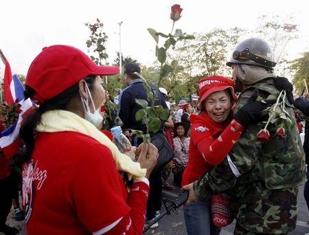 Thai troops surround protestors after 2 killed in clash