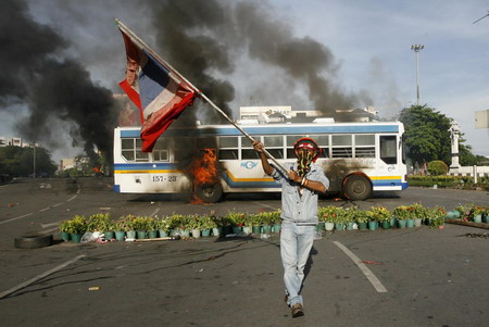 Thai troops surround protestors after 2 killed in clash