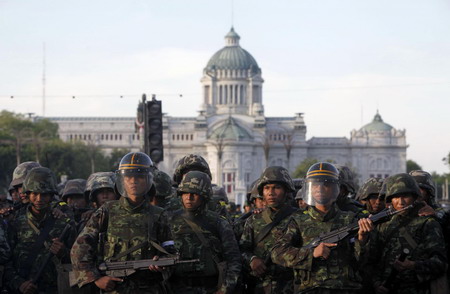 Thai troops surround protestors after 2 killed in clash