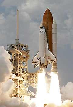 Atlantis inspected for damage while chasing Hubble