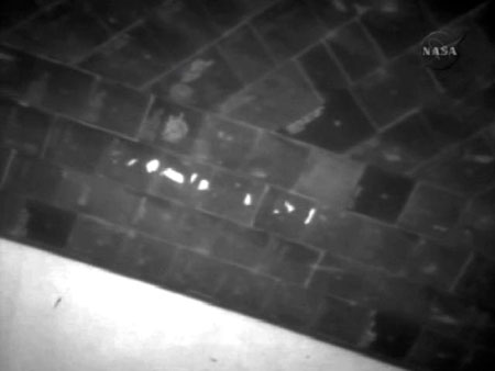 Atlantis inspected for damage while chasing Hubble