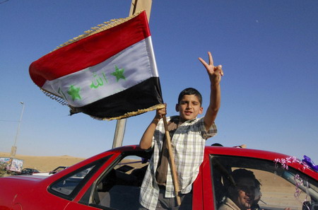 Iraqis celebrate US pullback but bombing kills 33