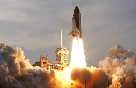 On sixth try, space shuttle lifts off