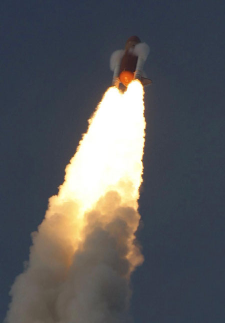 On sixth try, space shuttle lifts off