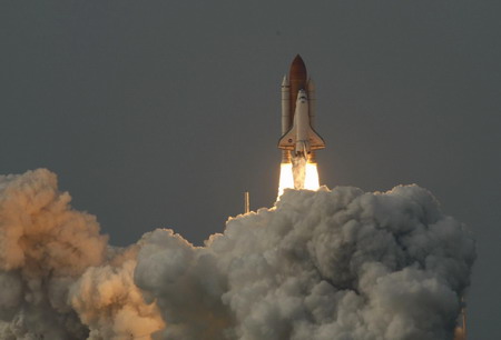 On sixth try, space shuttle lifts off