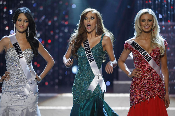 Miss California Alyssa Campanella (C) reacts as she is chosen as the last of the final four finalists during the 2011 Miss USA pageant in the Theatre for the Performing Arts at Planet Hollywood Hotel and Casino in Las Vegas, Nevada, June 19, 2011. Miss Hawaii Angela Byrd (L) and and Miss Maryland Allyn Rose stand by. 21-yr-old Californian crowned Miss USA