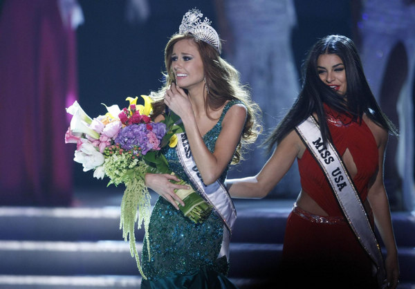 Miss California Alyssa Campanella (L) begins her walk after being crowned Miss USA 2011 by Rima Fakih (R), Miss USA 2010, during the Miss USA pageant in the Theatre for the Performing Arts at Planet Hollywood Hotel and Casino in Las Vegas, Nevada June 19, 2011. 21-yr-old Californian crowned Miss USA