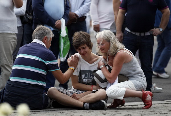 A young man is comforted as he mourns for the victims of the massacre on an island in the countryside and the bomb blast in the capital Oslo July 23, 2011. Norway shooter traumatises nation, up to 98 dead