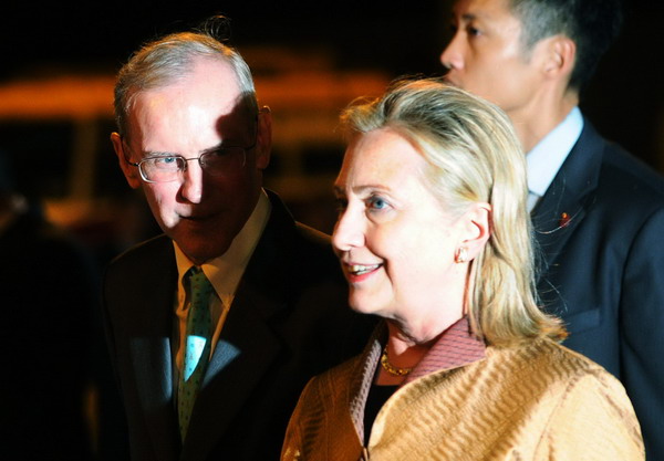 US Secretary of State Hilary Clinton (R) listens to US Consul General Stephen Young upon arriving in Hong Kong July 24, 2011. Under debt shadow, Clinton to push Asia on trade