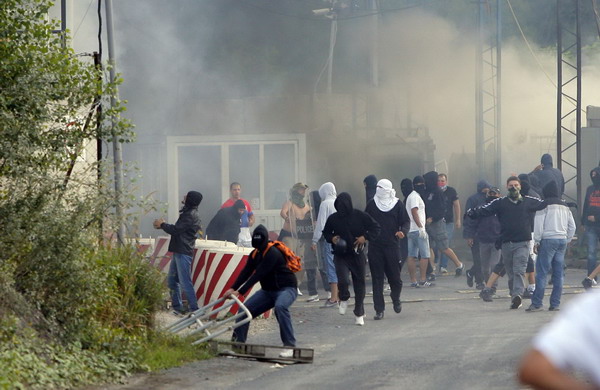 Masked Serb extremists set the Serbia-Kosovo border crossing on fire in Jarinje July 27, 2011. Violence in north Kosovo draws EU warning