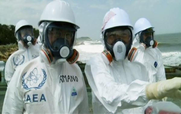 Director General of the International Atomic Energy Agency Yukiya Amano (L) inspects the site of Tokyo Electric Power Company (TEPCO)'s Fukushima Daiichi nuclear power plant in Fukushima Prefecture, in this still image taken from video July 25, 2011. Waters off Fukushima affected by radiation