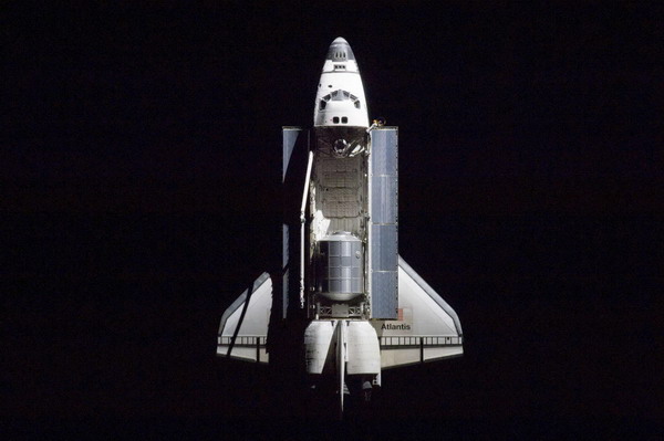A 400 millimeter lens was used by an International space station crew member to capture this image of the space shuttle Atlantis as it drew close to the station for docking in this photo provided by NASA and taken July 10, 2011. Post-shuttle, US space explorers need not be human