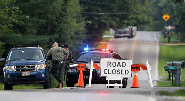 Law enforcement officers set up a road block as investigations continue near the scene of a shooting in Copley, Ohio August 7, 2011. Seven people, including an 11-year-old, were slain on Sunday before police killed the alleged gunman in the small town near Akron, Ohio, police said. Police: 8 shot to death in Ohio, including child