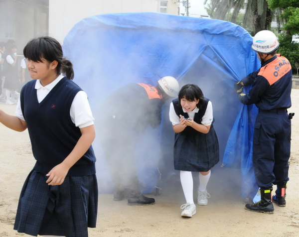 Students and firefighters participate in a disaster drill in Osaka, Japan, Sept 1, 2011. Japan disaster drills hold greater sense of urgency