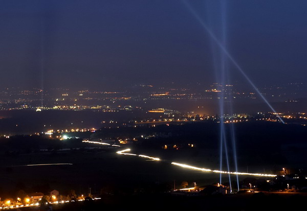 File photo of spotlights aimed at the sky above ground along the 27 km (16.7 miles) path of the underground ring of the LHC (Large Hadron Collider) of the CERN (Centre Europeen de Recherche Nucleaire) in Geneva September 29, 2004, to celebrate CERN's 50th anniversary. Nobel laureates doubt superluminal neutrino experiment