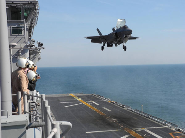 The 16-ton fighter jet slowed to a stop off the warship's port beam, where it hovered like a floating rock as thousands of pounds of thrust from its engine and lift fan stirred up a cloud of mist from the Atlantic Ocean 100 feet below. F-35 makes headway amid criticism