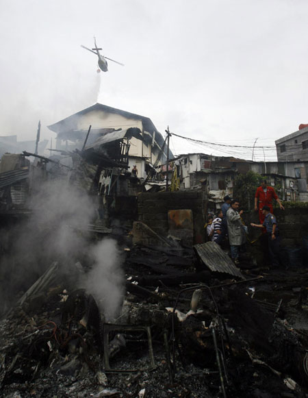Plane crashes into Philippines slum, 13 dead