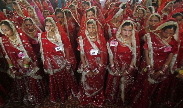 Bejeweled brides attend a mass marriage ceremony at Noida on the outskirts of New Delhi December 17, 2011. Mass marriage ceremony in India