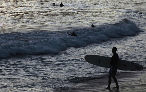 Surfer takes to the water in Rio de Janeiro