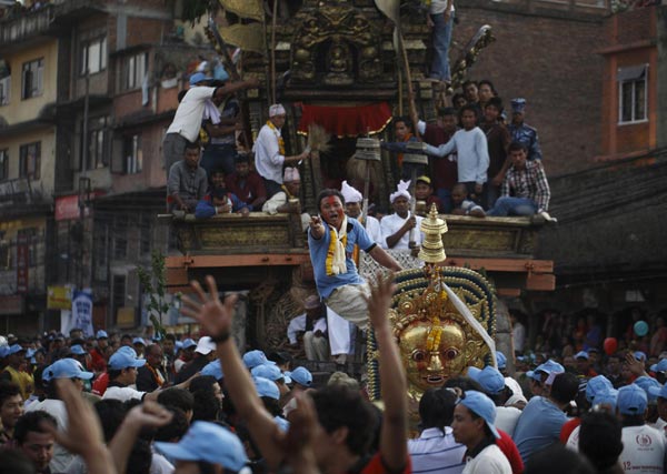 People celebrate the chariot festival for rain