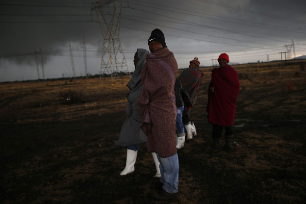 Striking mineworkers march S. African miners march outside Marikana mine