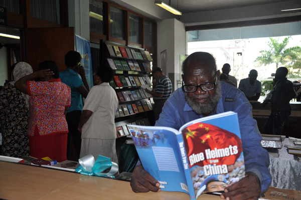 A man reads a book donated by the Experience China project at the National Central Library of Tanzania in Dar es Salaam on Monday. Liu Xiangrui / China Daily Library helps Tanzanians better understand China
