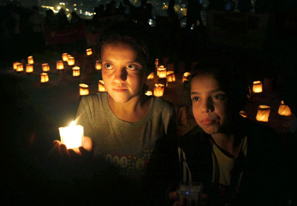 Syrian children living in Amman take part in a candlelit vigil at the Citadel in the Jordanian capital on Thursday to mark the second anniversary of the Syrian civil war. Raad Adayleh / Associated Press Political negotiations necessary for Syria: China