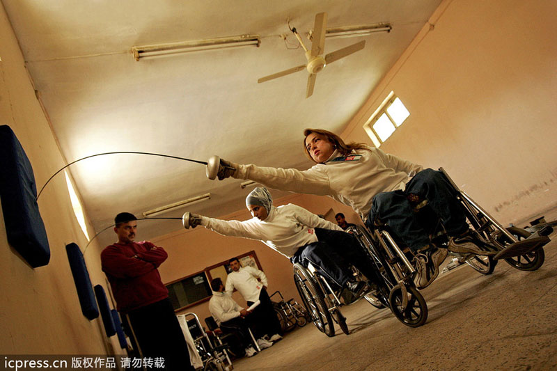 Disabled Iraqi fencing players Nadia Ali Abdel Karim (front) and Wafa Jadwal train at al-Wissam club in Baghdad, on Dec 11, 2004. Public sports in post-war Iraq