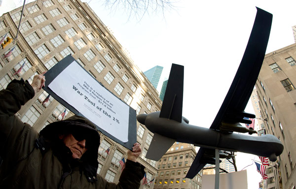 Members of Grandmothers Against the War, Granny Peace Brigade, the Raging Grannies and other groups hoist a model of a drone in the air as they protest the US military's use of drones during an 'April Days of Action' demonstration on Wednesday in New York. Don Emmert / Agence France-Presse Drones take toll on mental health