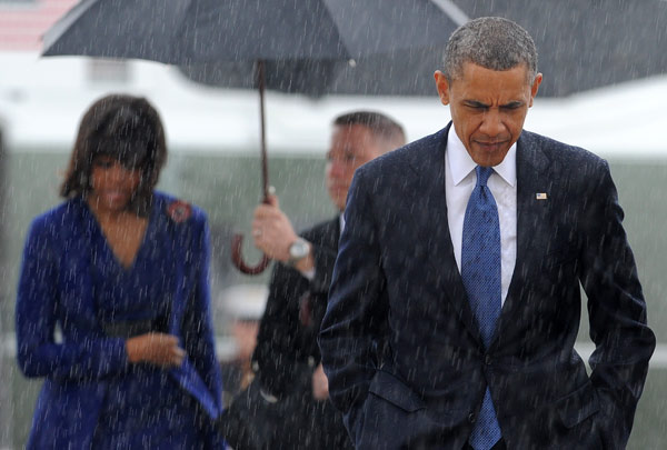 US President Barack Obama and First Lady Michelle Obama board Air Force One at Andrews Air Force Base in Maryland on Thursday. Obama was in Boston to mourn victims of the deadly marathon attacks, as investigators study images of a suspect who may have planted the bombs. Jewel Samad / Agence France-Presse Obama attends service for bombing victims