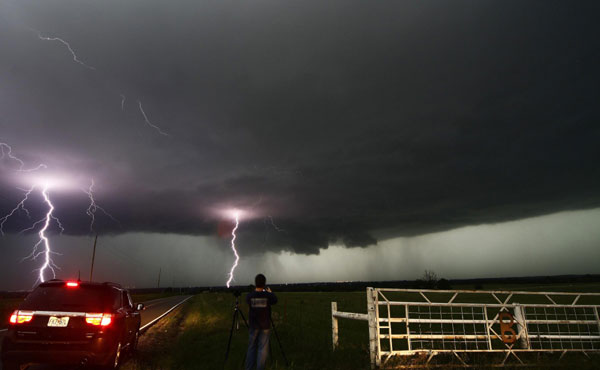 Cloud to ground lightning strikes near storm chasers during a tornadic thunderstorm in Cushing May 31, 2013. Oklahoma tornadoes kill at least nine