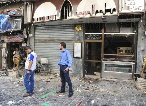 A view shows the site after bombs exploded close to a police post in the central Marjeh Square in Damascus June 11, 2013, in this handout photograph distributed by Syria's national news agency SANA. Twin blasts kill 14 in central Damascus