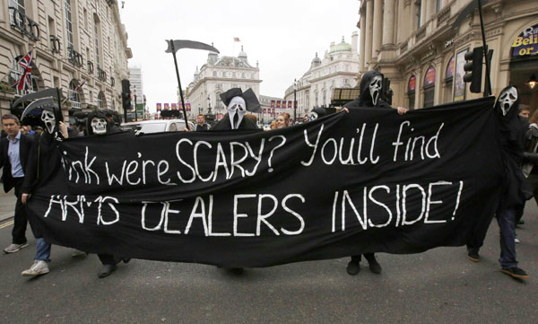 Demonstrators protesting against the upcoming G8 summit, being held near Enniskillen, Northern Ireland, hold a banner as they walk to BAE systems headquarters in central London, June 12, 2013. Anti-G8 protests aim for Canary Wharf banking district