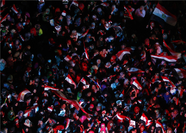 Female protesters who are against ousted Egyptian President Mohamed Morsi shout slogans as they hold Egypt flags at Tahrir square in Cairo, July 7, 2013. Huge crowds rally in Egypt, political talks stalled