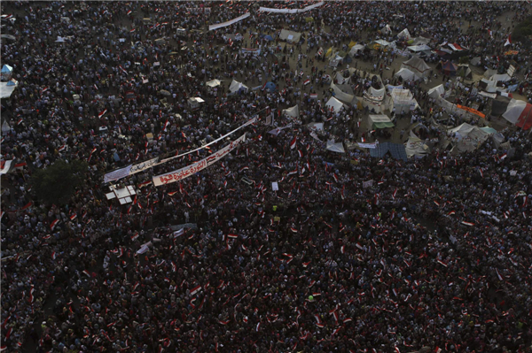 Protesters who are against deposed Egyptian President Mohamed Morsi hold Egypt flags and shout slogans at Tahrir square in Cairo, July 7, 2013. Huge crowds rally in Egypt, political talks stalled