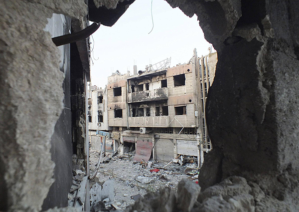 A view shows damaged buildings in the besieged area of Homs July 12, 2013. New front opens in Syria against al Qaida
