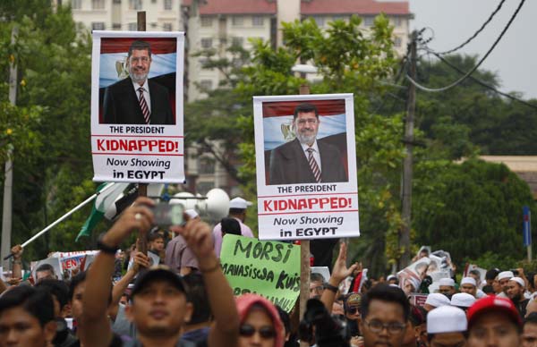 Protesters display posters of Egypt's ousted president Mohammed Morsi during a rally in support of the toppled leader in Kuala Lumpur, Malaysia, on Friday. Lai Seng Sin / Associated Press Egyptian army detains Morsi ahead of rallies