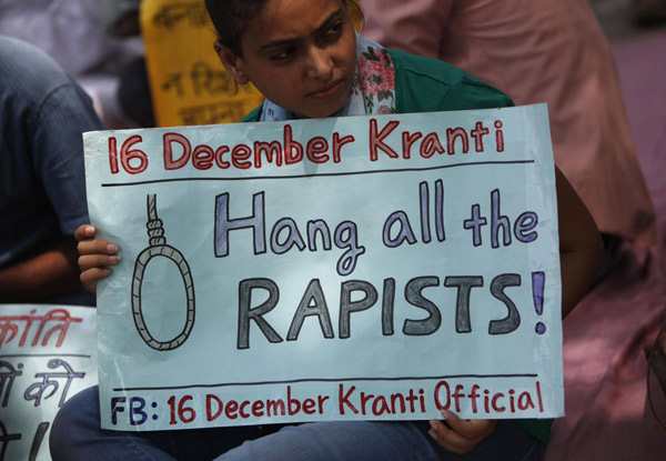 A demonstrator holds a placard during a protest against the verdict of a teenager, who was sentenced to three years in juvenile detention, in New Delhi September 1, 2013. India fury over gang rapes sign of change
